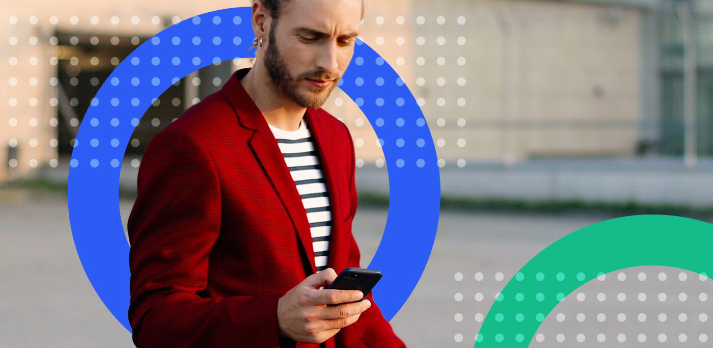 Man in red jacket reading mobile