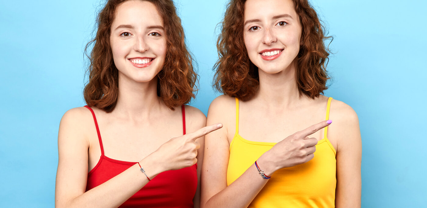 Identical twins pointing