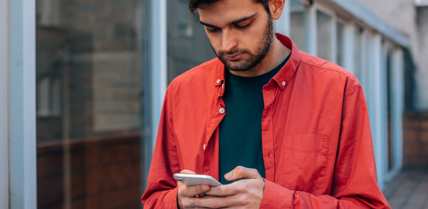Man checking his phone a bit unsure