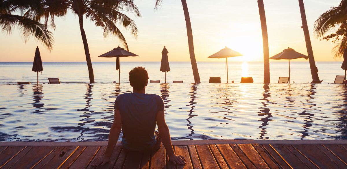 Man sitting by a swimming pool