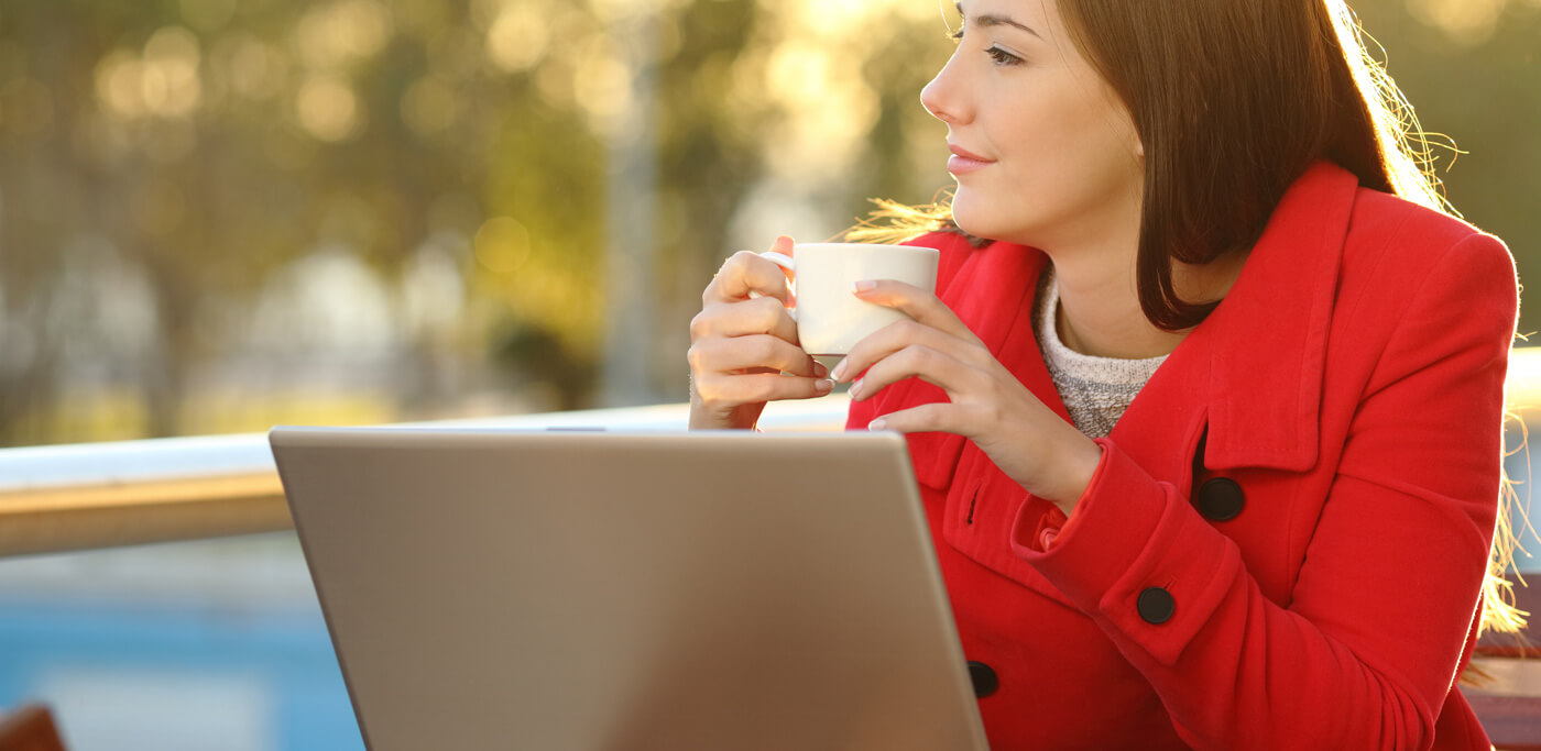 women on laptop with coffee