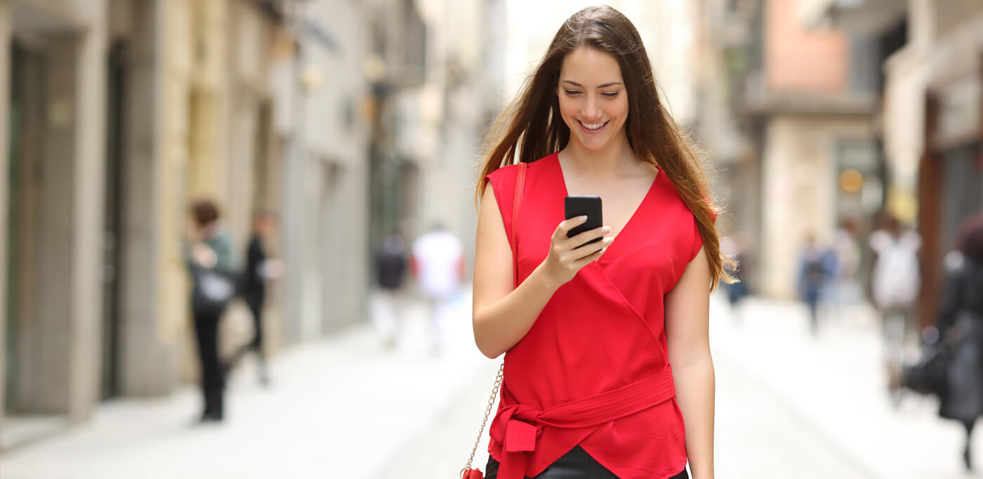 Women on phone walking on high street